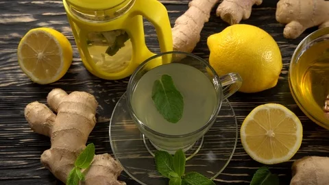 Ginger tea with lemon, mint and honey on wooden background. Stock Footage 75746947