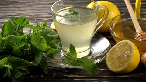 Ginger tea with lemon, mint and honey on wooden background. Stock Footage 75747366