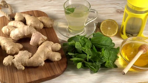 Ginger tea with lemon, mint and honey on wooden background. Stock Footage 75749793