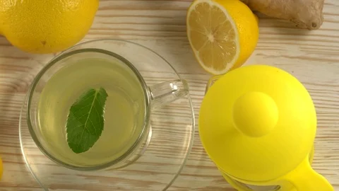 Ginger tea with lemon, mint and honey on wooden background. Stock Footage 75774083