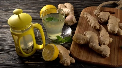 Ginger tea with lemon, mint and honey on wooden background. Stock Footage 75774346