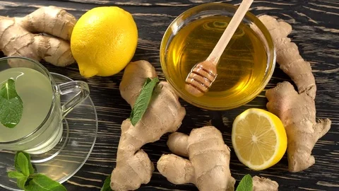 Ginger tea with lemon, mint and honey on wooden background. Stock Footage 75774570