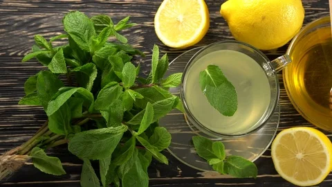 Ginger tea with lemon, mint and honey on wooden background. Stock Footage 75775323