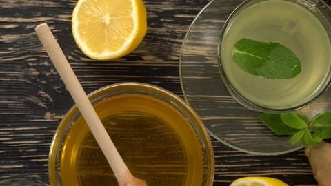 Ginger tea with lemon, mint and honey on wooden background. Stock Footage 75907509