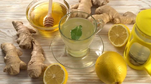Ginger tea with lemon, mint and honey on wooden background. Stock Footage 75910224