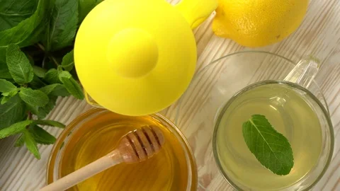 Ginger tea with lemon, mint and honey on wooden background. Stock Footage 75910821