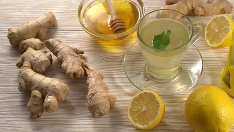 Ginger tea with lemon, mint and honey on wooden background. Stock Footage 76552316