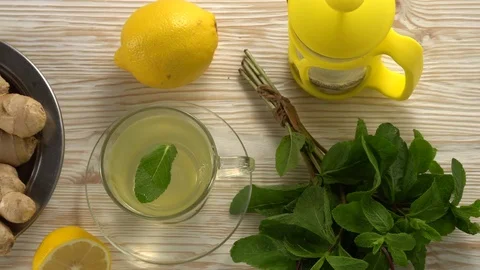 Ginger tea with lemon, mint and honey on wooden background. Stock Footage 76553070