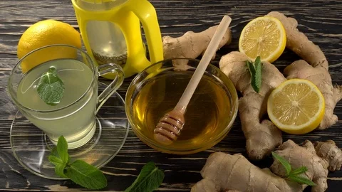 Ginger tea with lemon, mint and honey on wooden background. Stock Footage 76574016