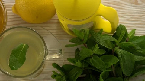 Ginger tea with lemon, mint and honey on wooden background. Stock Footage 76576042