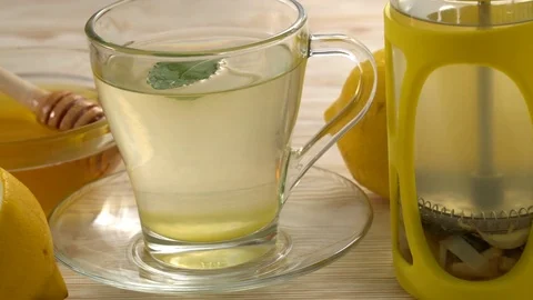 Ginger tea with lemon, mint and honey on wooden background. Stock Footage 76577115