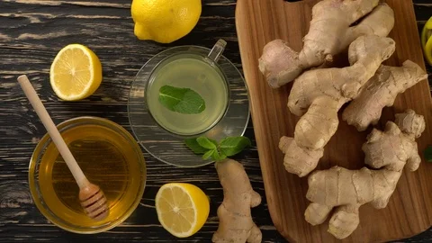 Ginger tea with lemon, mint and honey on wooden background. Stock Footage 76643413