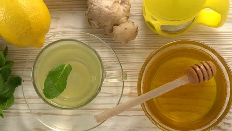 Ginger tea with lemon, mint and honey on wooden background. Stock Footage 76644029