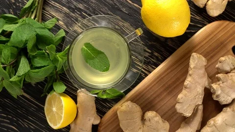 Ginger tea with lemon, mint and honey on wooden background. Stock Footage 76687090