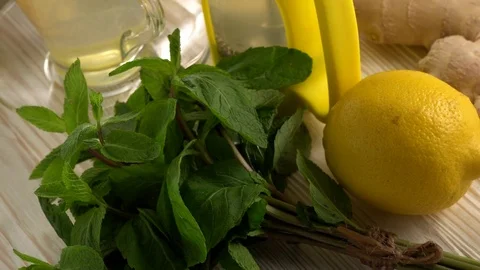 Ginger tea with lemon, mint and honey on wooden background. Stock Footage 76687394