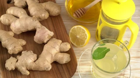 Ginger tea with lemon, mint and honey on wooden background. Stock Footage 76687652