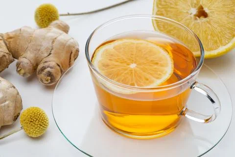 Ginger tea with lemon slice and fresh lemon on a white background Stock Photos