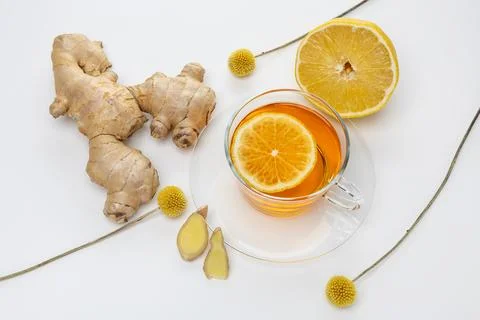 Ginger tea with lemon slice and ginger root on white background for healthy.. Stock Photos