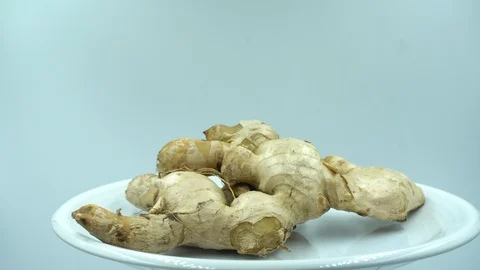 Ginger white raw background rotating in white plate. Stock Footage 124024659