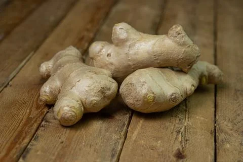 Ginger on a wooden background. Ginger root.  Stock Photos