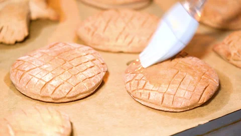 Gingerbread on a baking sheet coated with melted butter Stockbeeldmateriaal 251542590