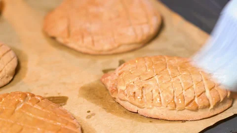Gingerbread on a baking sheet coated with melted butter Stock Footage 251542994