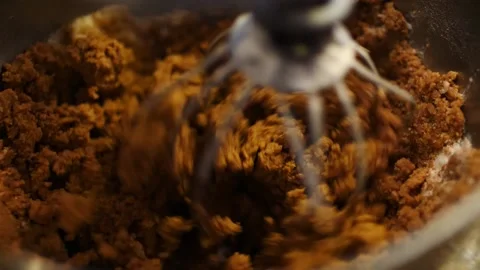 Gingerbread cookie batter being mixed and mixer in slow motion close up Stock Footage 217356180
