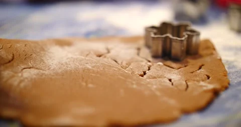 Gingerbread cookie being cut out of cookie dough cookie cutter Stock Footage 217358729