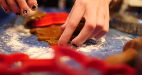 Gingerbread cookie dough being cut into gingerbread for Christmas Video stock 217357204