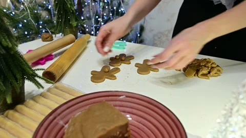 Gingerbread cookies are arranged by hands in a Christmas setting Stock Footage 344821683
