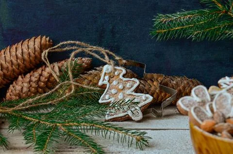 Gingerbread cookies in assorted shapes lie scattered on textured painted surf Stock Photos