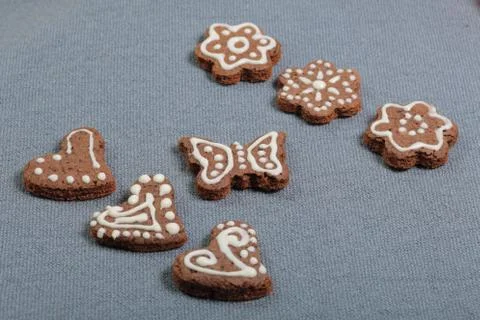 Gingerbread cookies decorated with a pattern of white glaze. On a background  Stock Photos