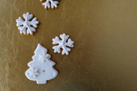 Gingerbread cookies in the form of a Christmas tree on a gold background. Stock Photos