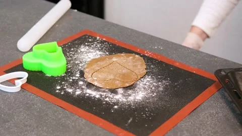 Gingerbread dough with a printed heart shape lies on a baking mat Stock Footage 201684717