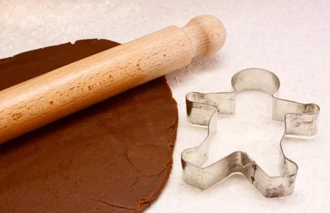 Gingerbread dough, rolling pin and cookie cutter Stock Photos