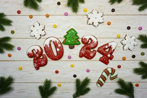 Gingerbread figures 2024 are laid out on a wooden table Stock Photos