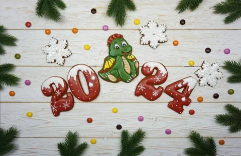 Gingerbread figures 2024 are laid out on a wooden table Stock Photos