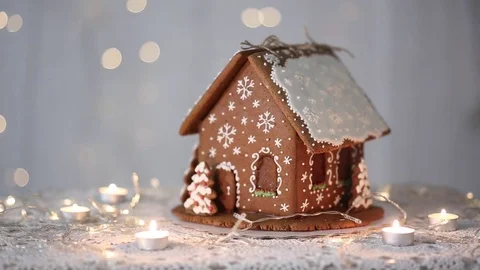 Gingerbread house on the background of lights, decorated with snowflakes Stock Footage 70790941