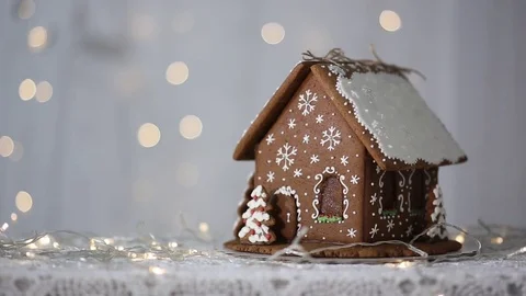 Gingerbread house on the background of lights, decorated with snowflakes Video stock 70791217