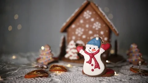 Gingerbread house on the background of lights, snowman and Christmas tree 動画素材 70790881
