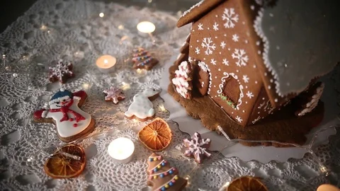 Gingerbread house on the background of lights, snowman and Christmas tree Stock Footage 70791037