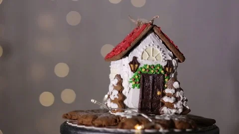 Gingerbread house on the background of lights, white and chocolate glaze Stock Footage 70791163