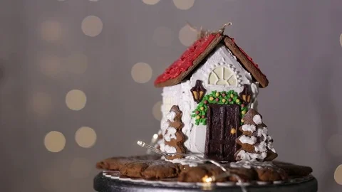 Gingerbread house on the background of lights, white and chocolate glaze Stock Footage 70791200