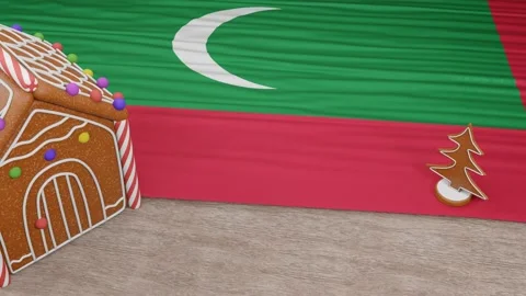 Gingerbread house with the flag of Maldives on the table Video stock 167764760