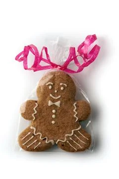 Gingerbread man in cellophane wrapper isolated on white background Stock Photos