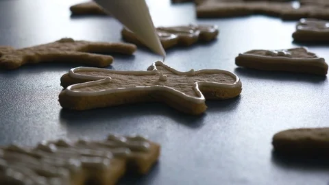 Gingerbread man cookie is decorated with glaze, closeup 4K color graded Stock Footage 83672146