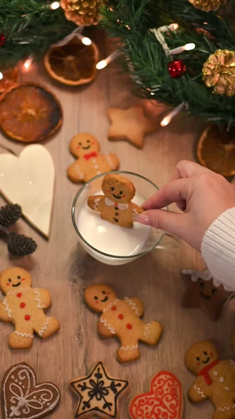 Gingerbread man into a cup of milk Stock Footage 294936421