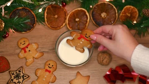 Gingerbread man into a cup of milk Stock Footage 294936434