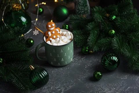 Gingerbread man decorating hot cocoa with marshmallows for Christmas Stock Photos