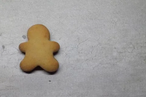Gingerbread man on a gray textural background with space for text Stock Photos